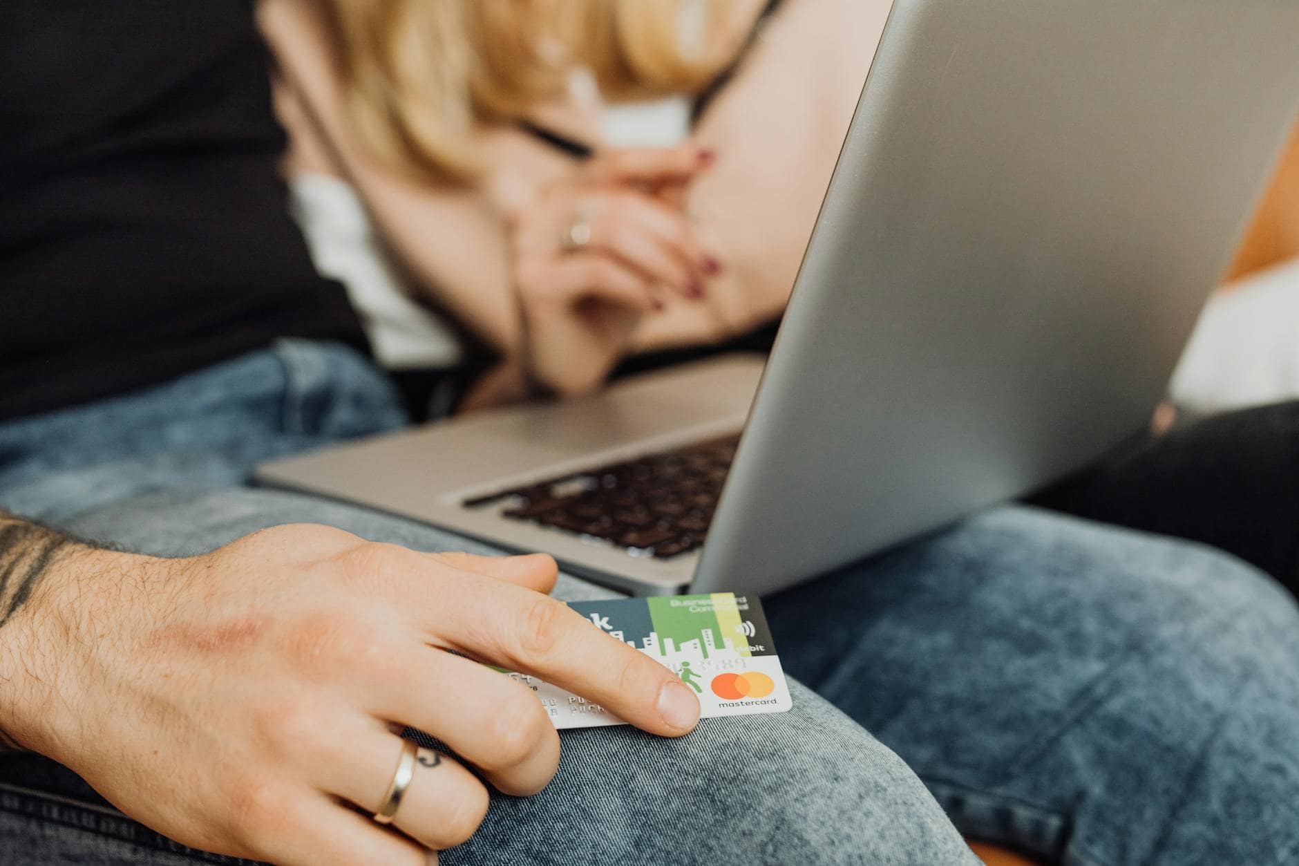 Couple booking a TUI holiday online with a credit card