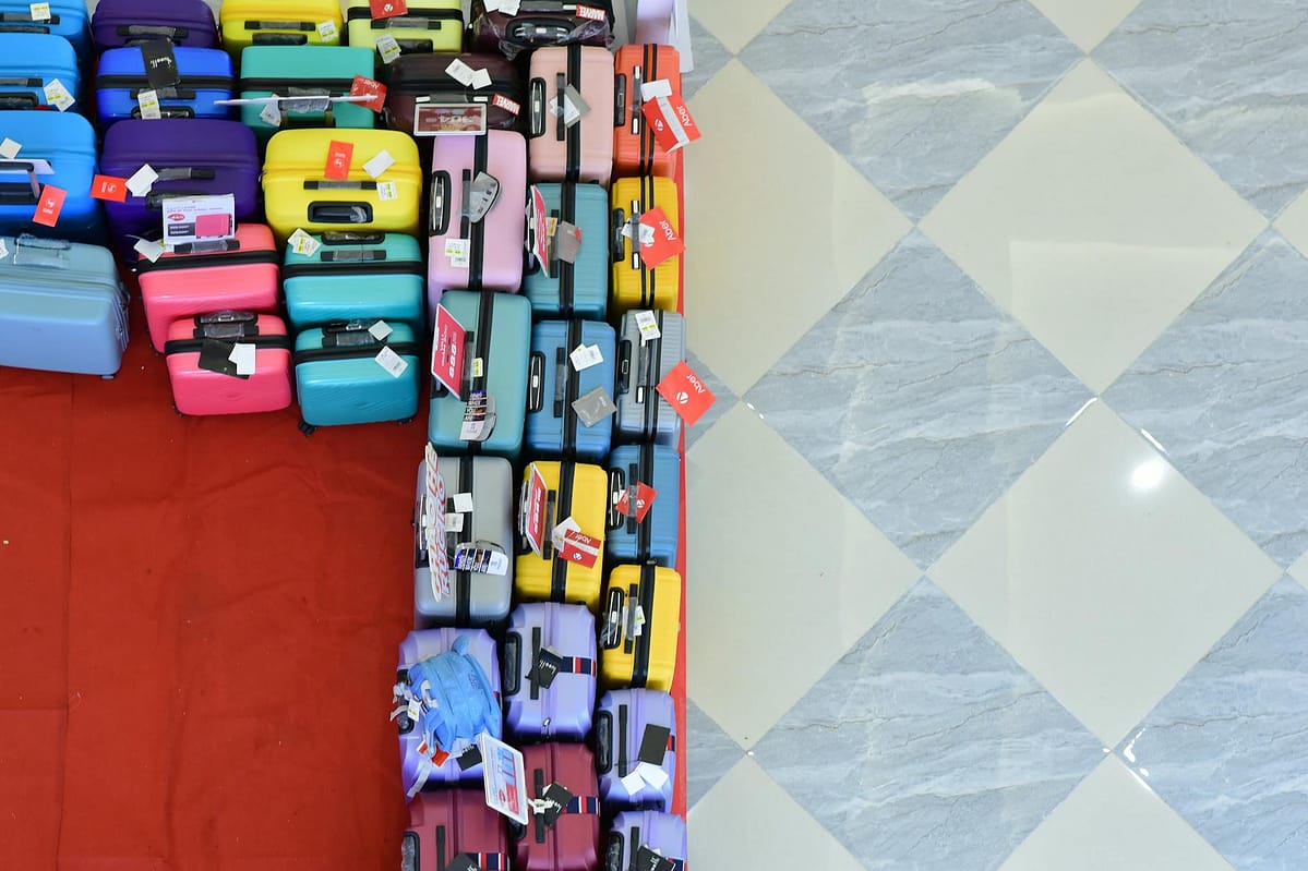 colorful suitcases displayed on checkered floor