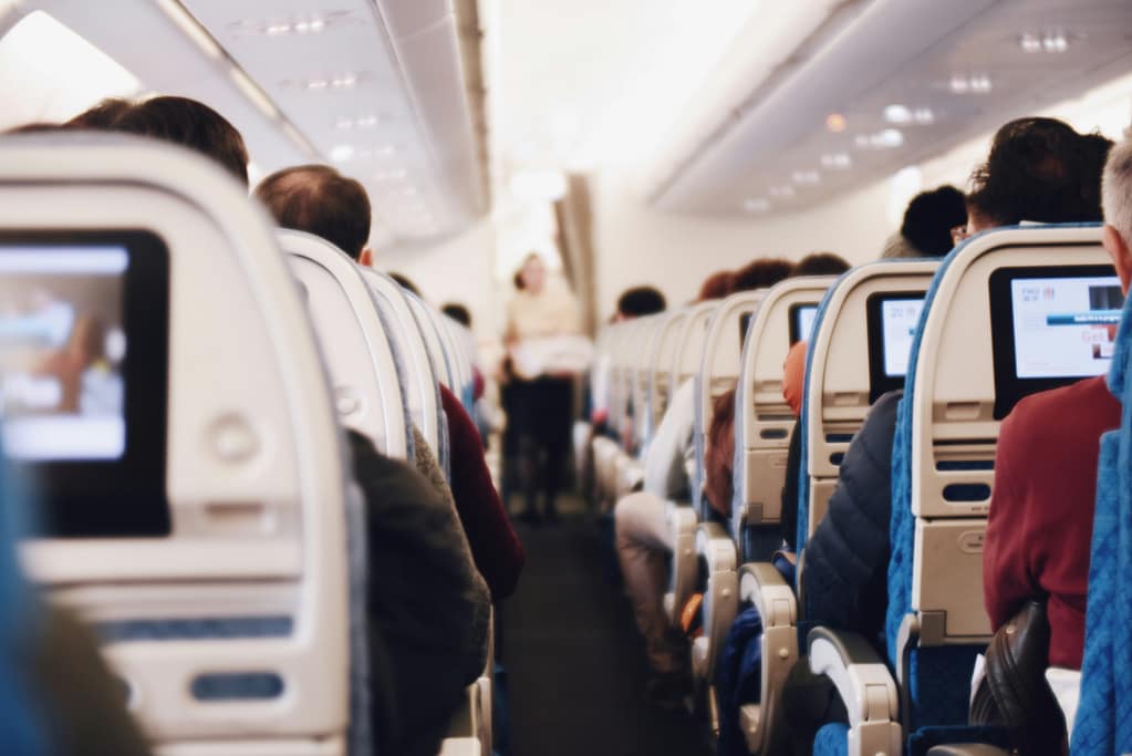 Passengers in a plane aisle