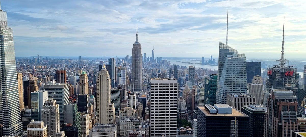 Aerial view of New York City skyline under a dramatic cloudy sky