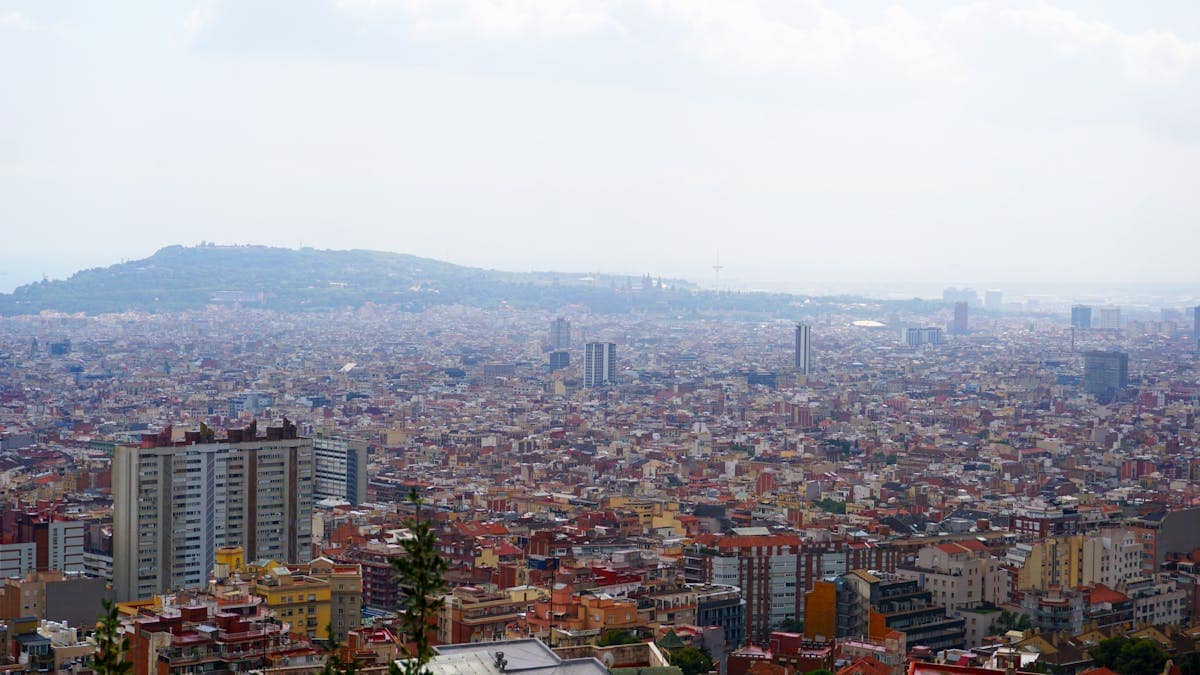 Aerial view of central Barcelona showing the Eixample grid district and the city stretching to the sea, Catalonia, Spain