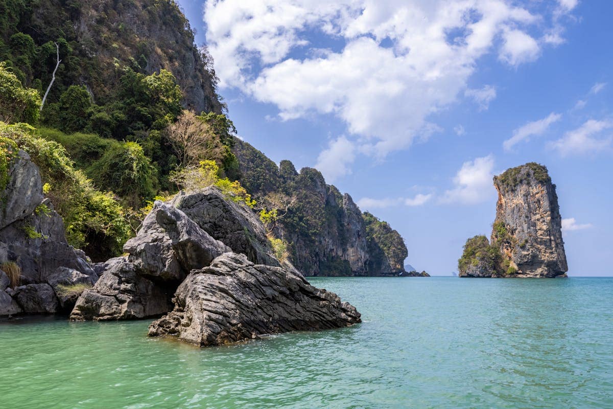 Rock formations and limestone cliffs above the turquoise water of Ao Nang Beach in Krabi, Thailand