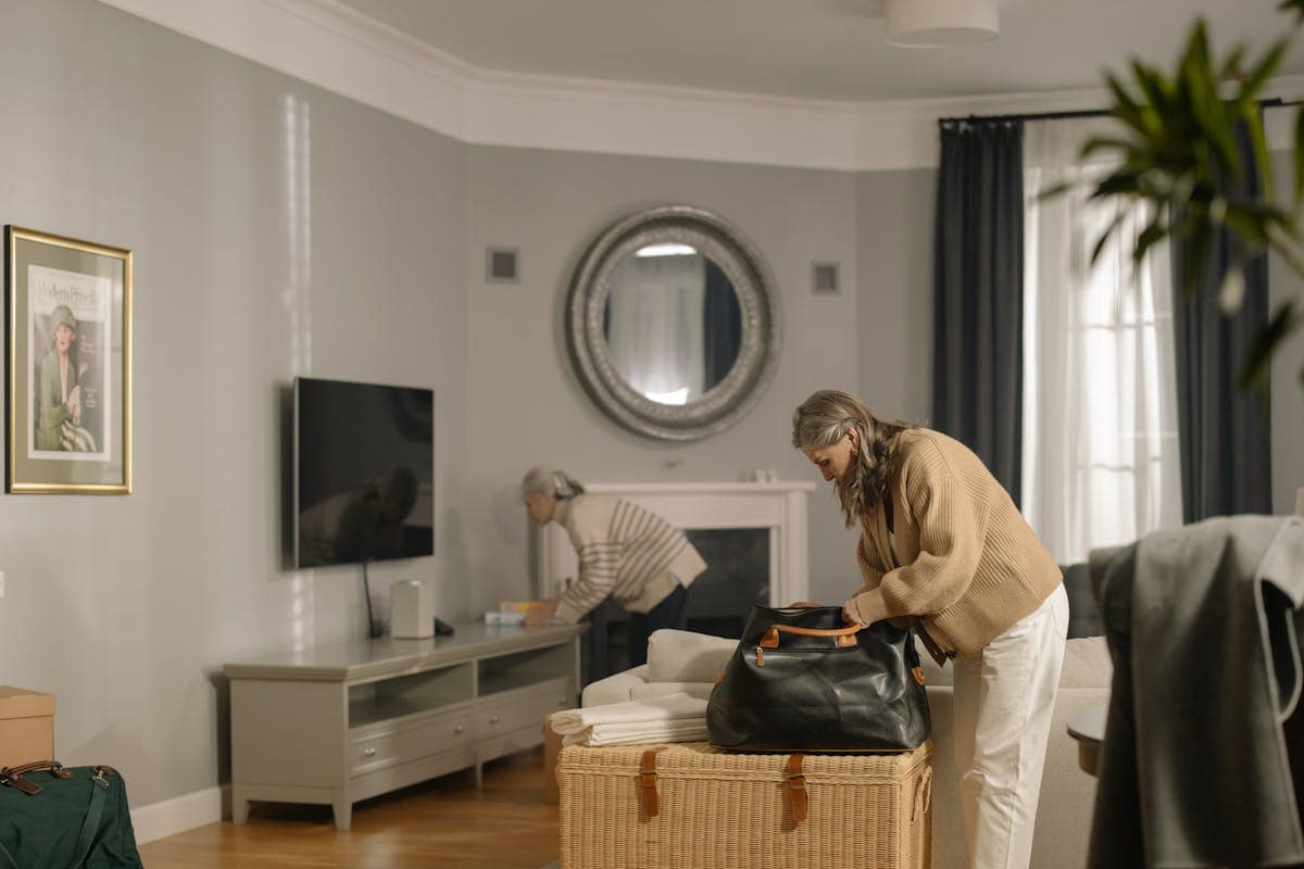Woman packing a travel bag at home before a flight, checking what fits