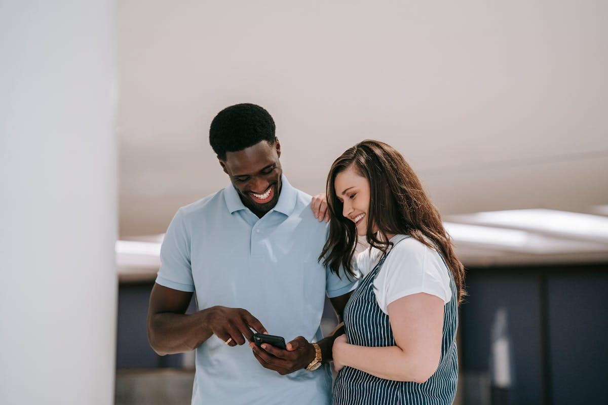 Couple smiling while looking at phone showing easyJet deal