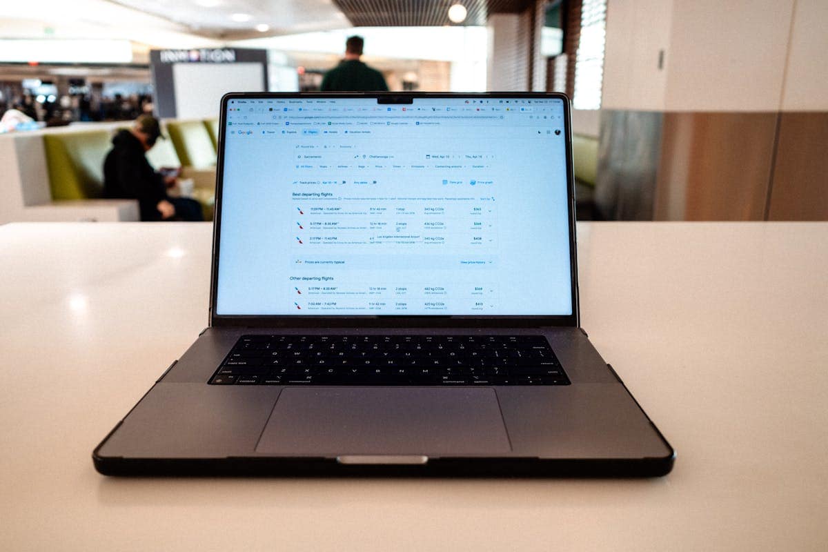 Laptop screen displaying a flight booking search results page