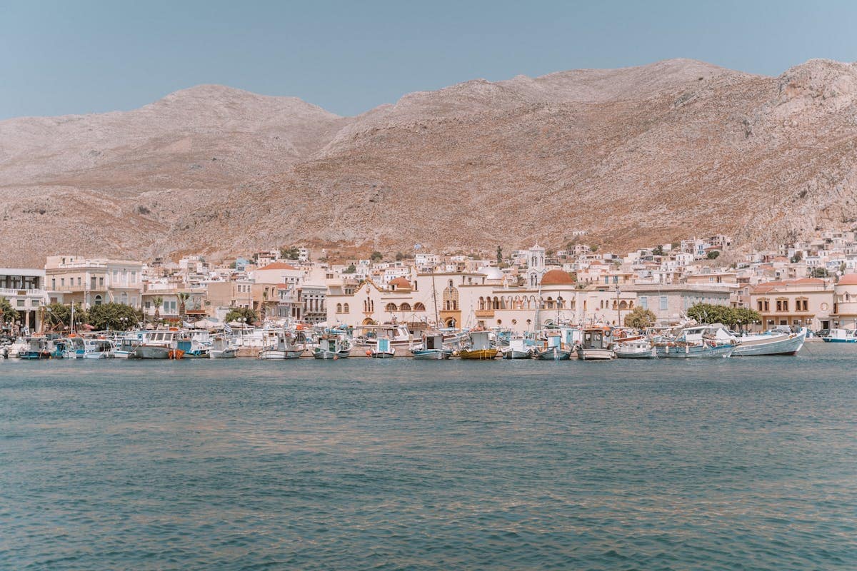 Colourful fishing boats moored in a harbour in a Greek island village
