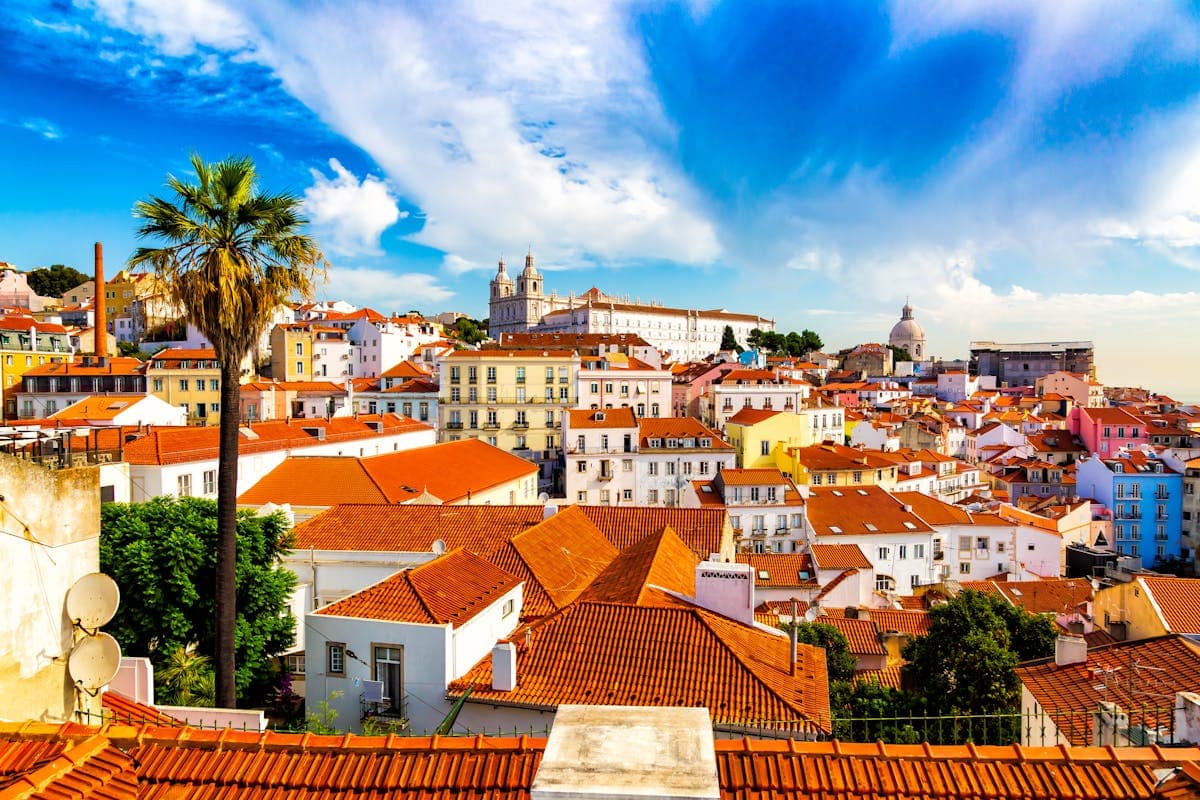 View over the red-roofed Alfama neighbourhood from one of Lisbon's hilltop miradouros