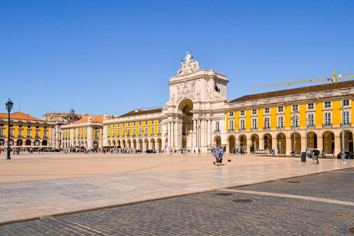 Praça do Comércio in Lisbon with the Rua Augusta Arch under a deep blue sky