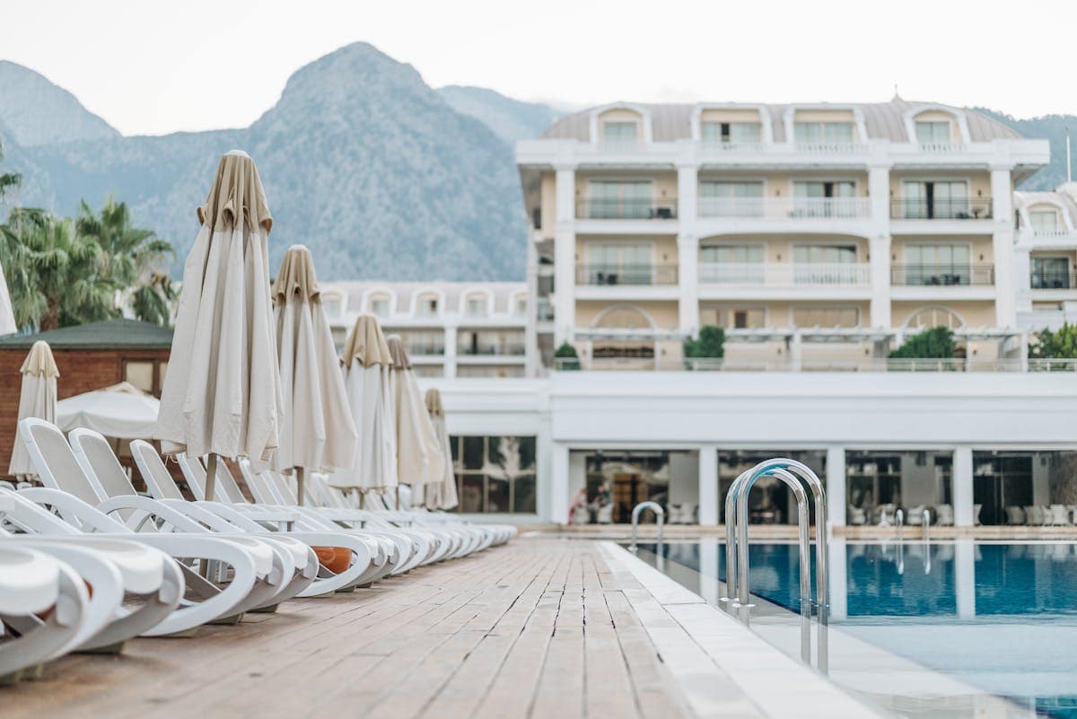 Resort swimming pool lined with sunloungers and parasols, typical of a TUI all-inclusive holiday destination