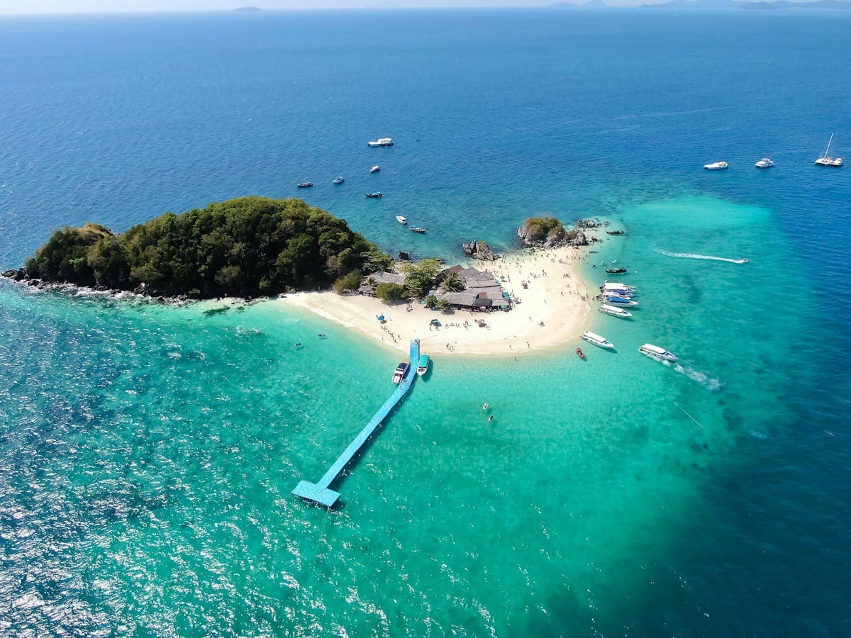 Aerial drone view of Koh Khai Nai island with turquoise water and white sand beach, Phuket Thailand