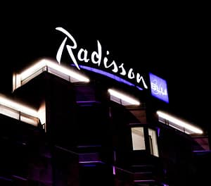 Radisson Blu hotel sign illuminated at night