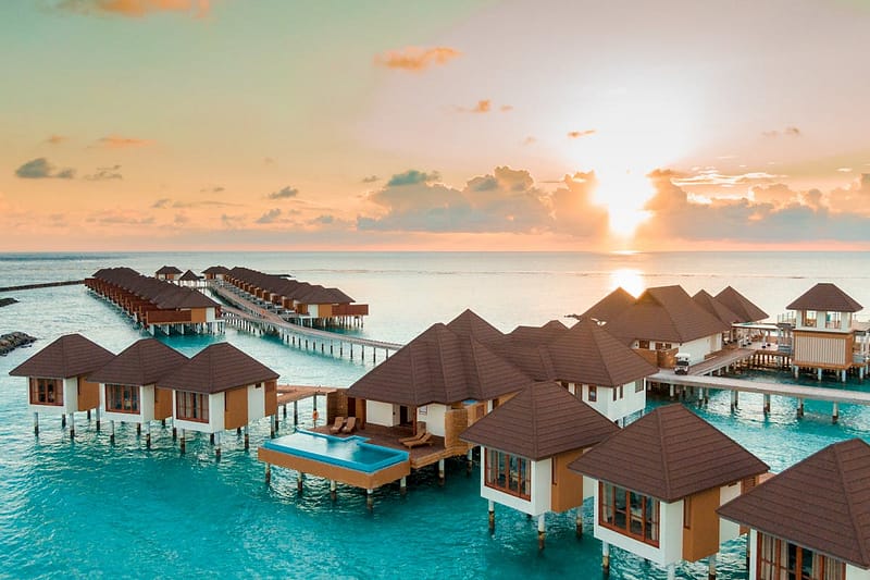 Maldives overwater bungalows at sunset — BA Holidays long-haul packages