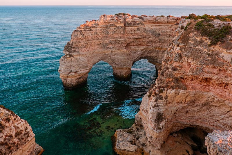 Rock arch at Praia da Marinha beach, Algarve, Portugal, at sunset