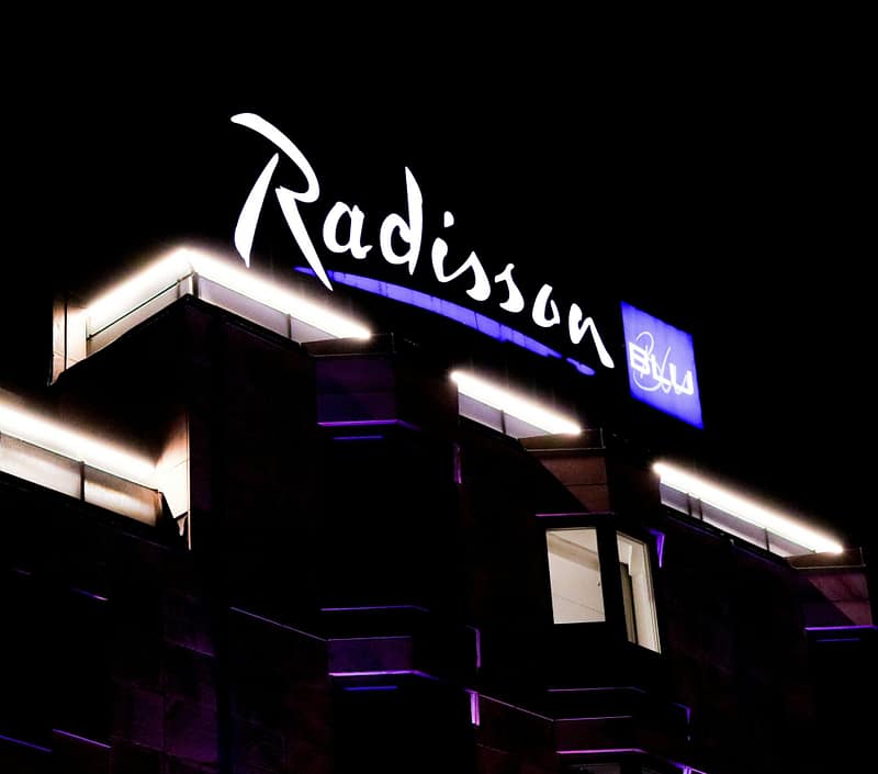 Radisson Blu hotel sign illuminated at night