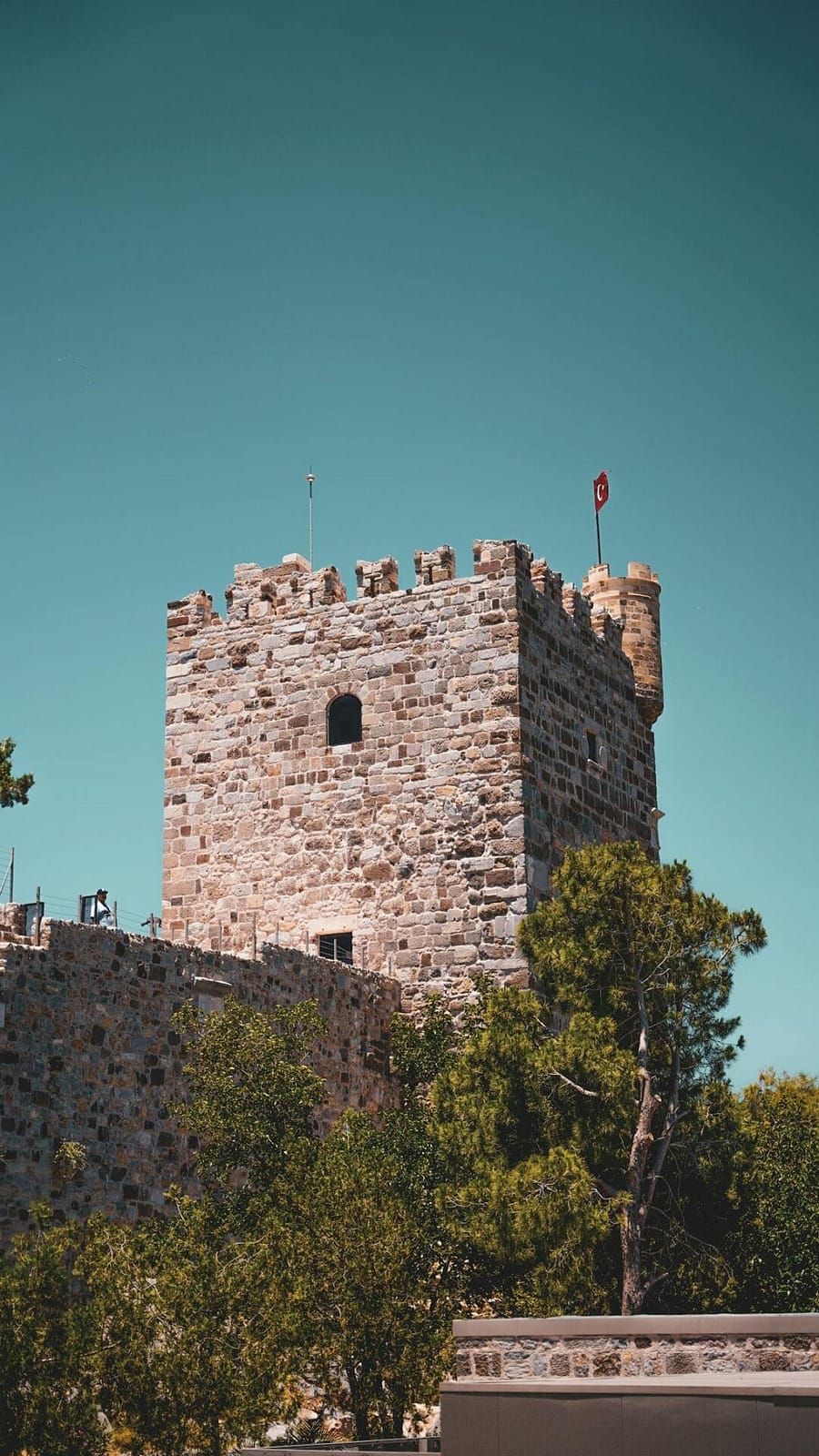 The Castle of St Peter (Bodrum Castle) rising above the turquoise harbour at Bodrum, Turkey