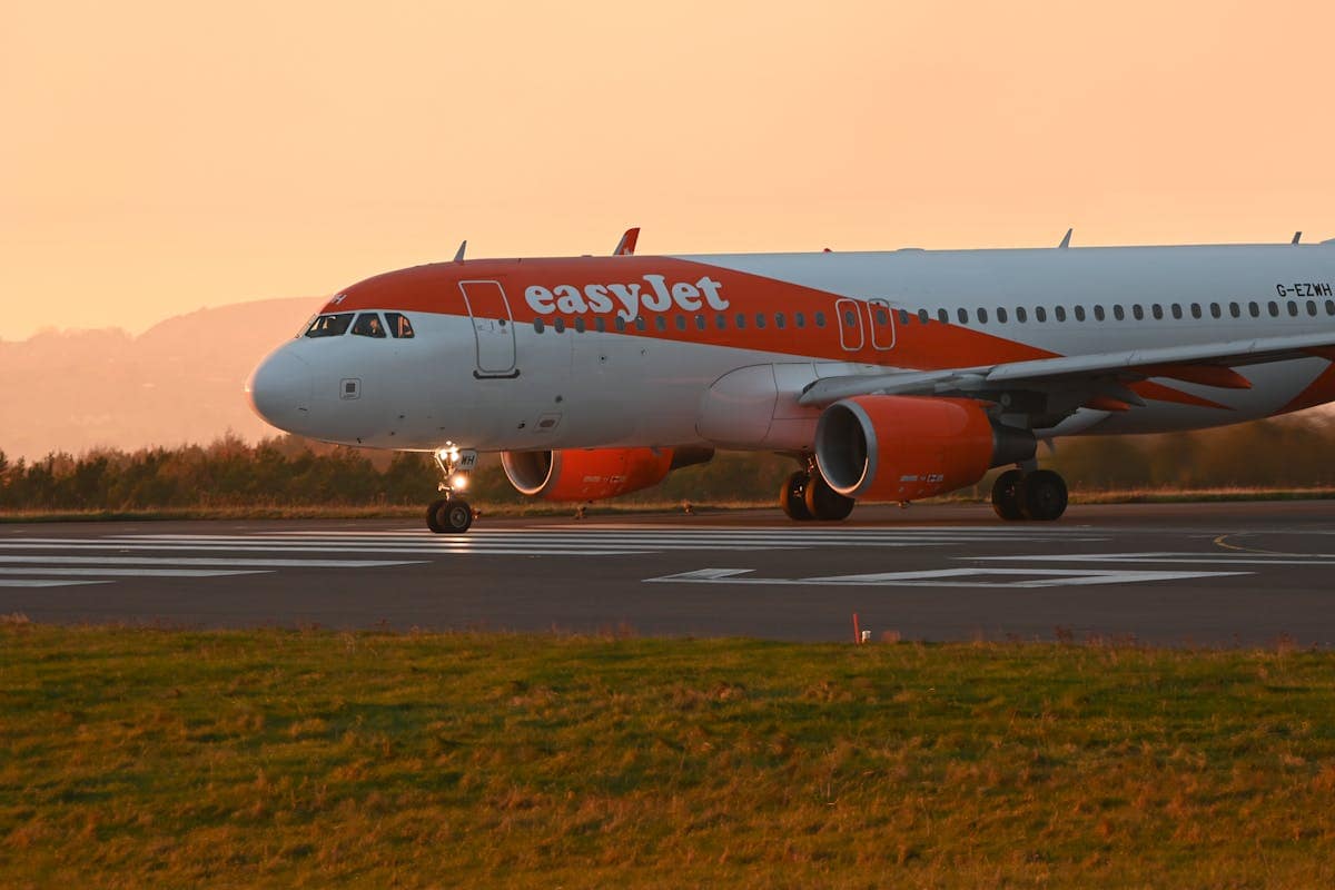 easyJet aircraft on the runway at sunset, ready for departure