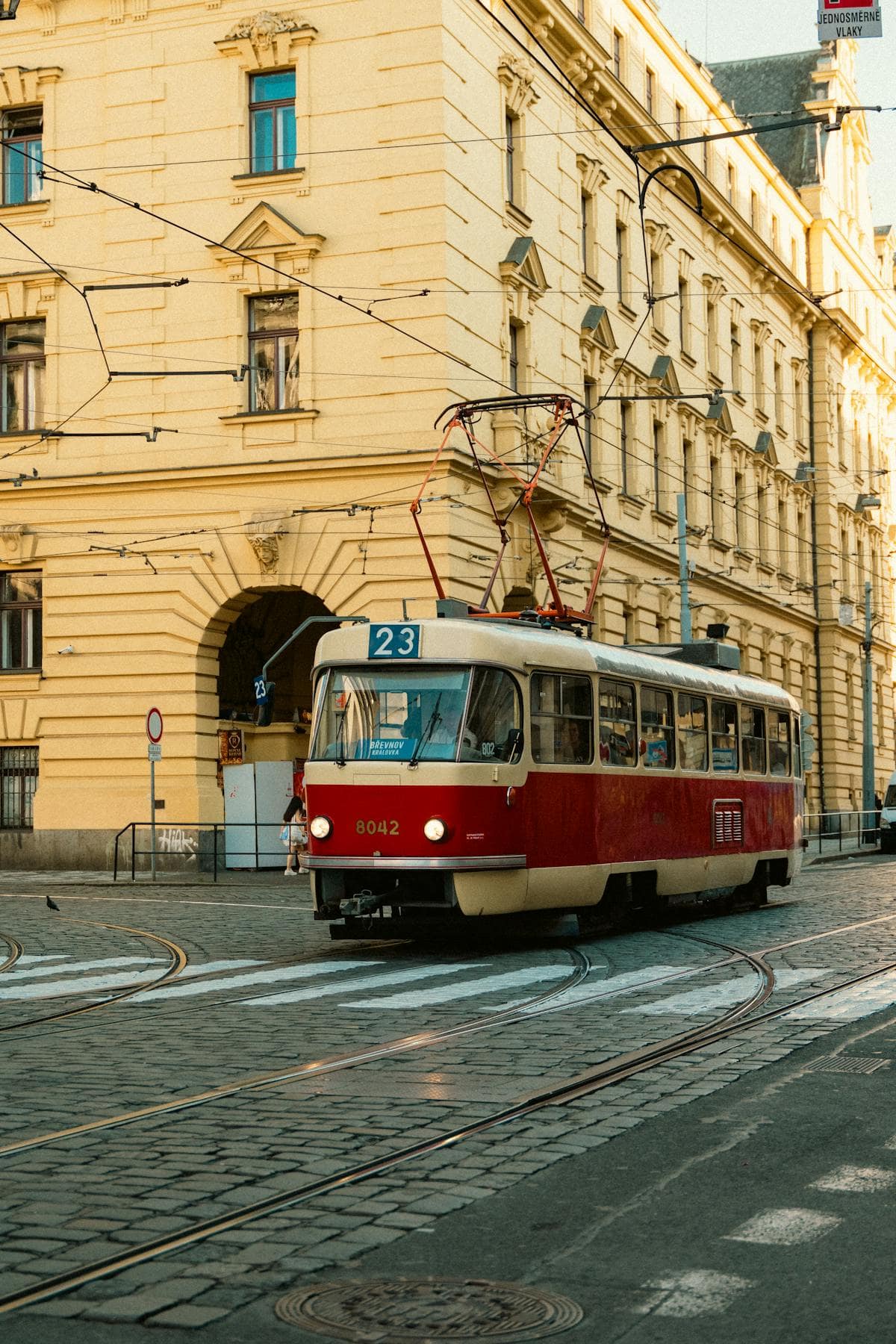 Vintage red tram on a cobbled Prague street