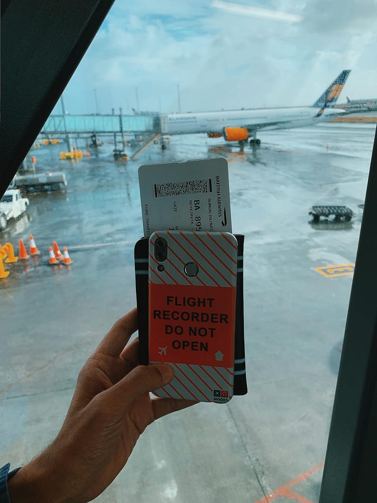Traveller checking boarding pass on smartphone at airport