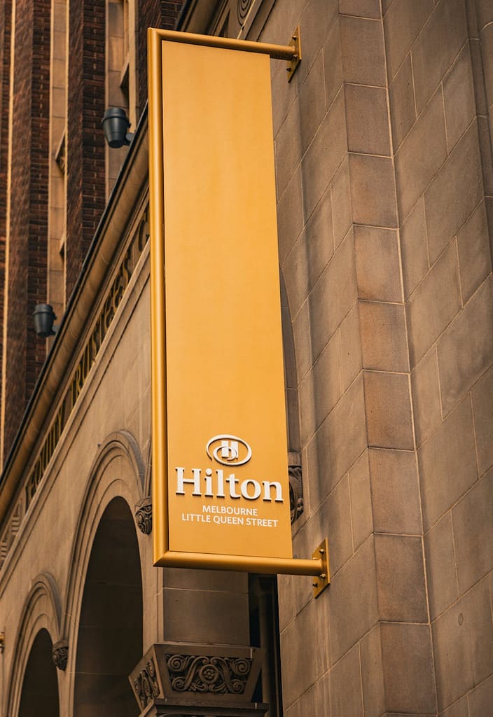 hilton hotel sign on historic building in melbourne